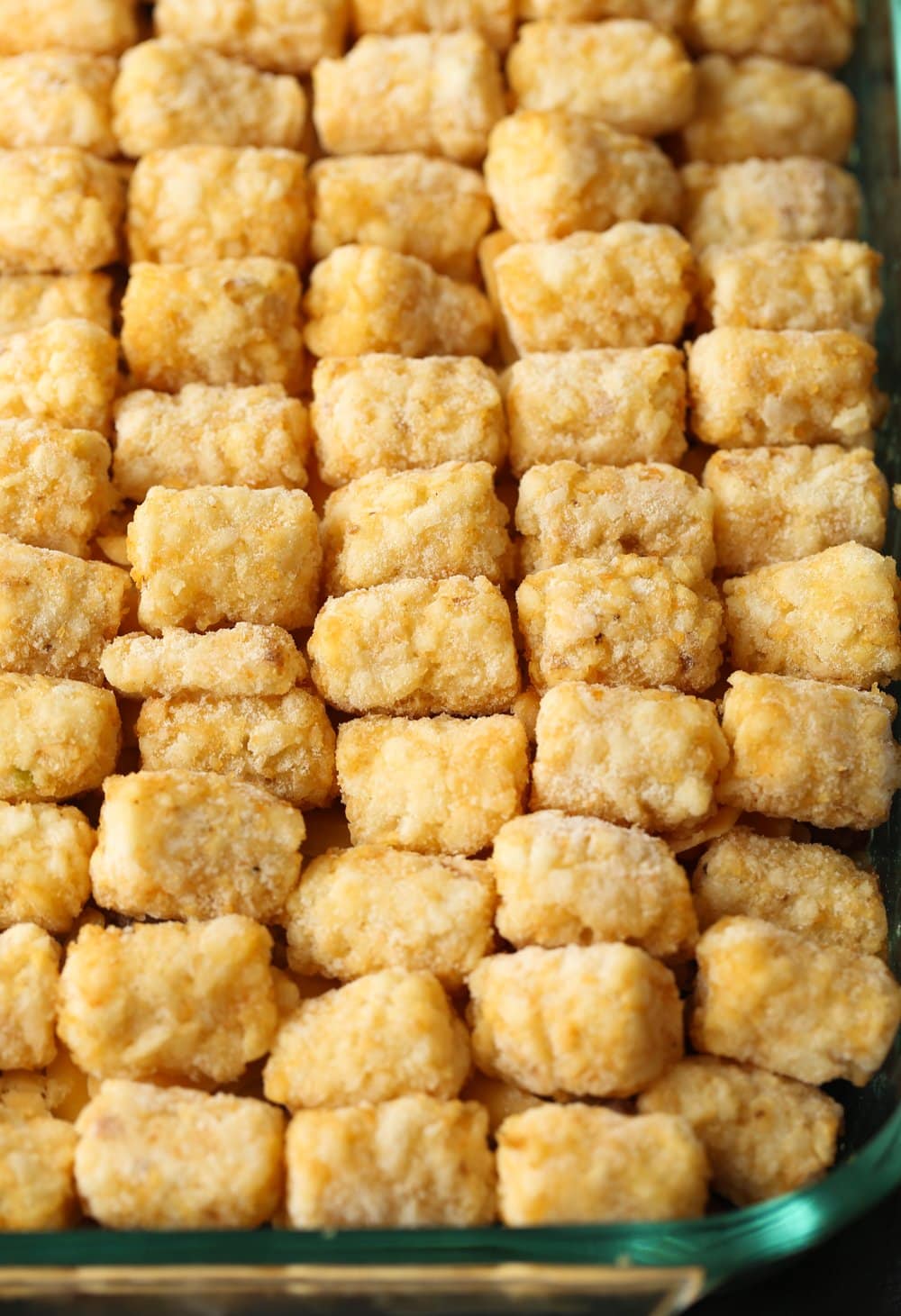 Unbaked hot dish casserole filled with frozen tater tots