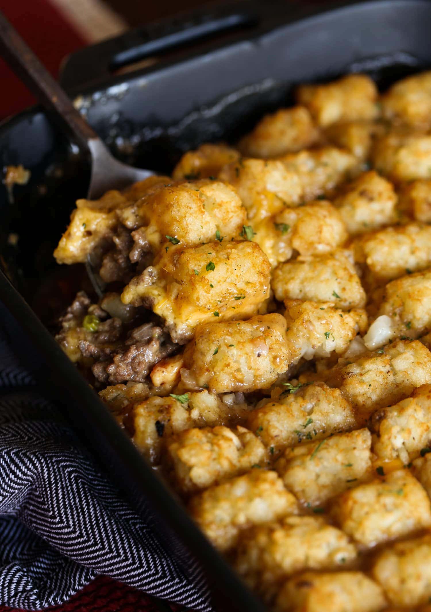 Spoonful of cheesy tater tot casserole.