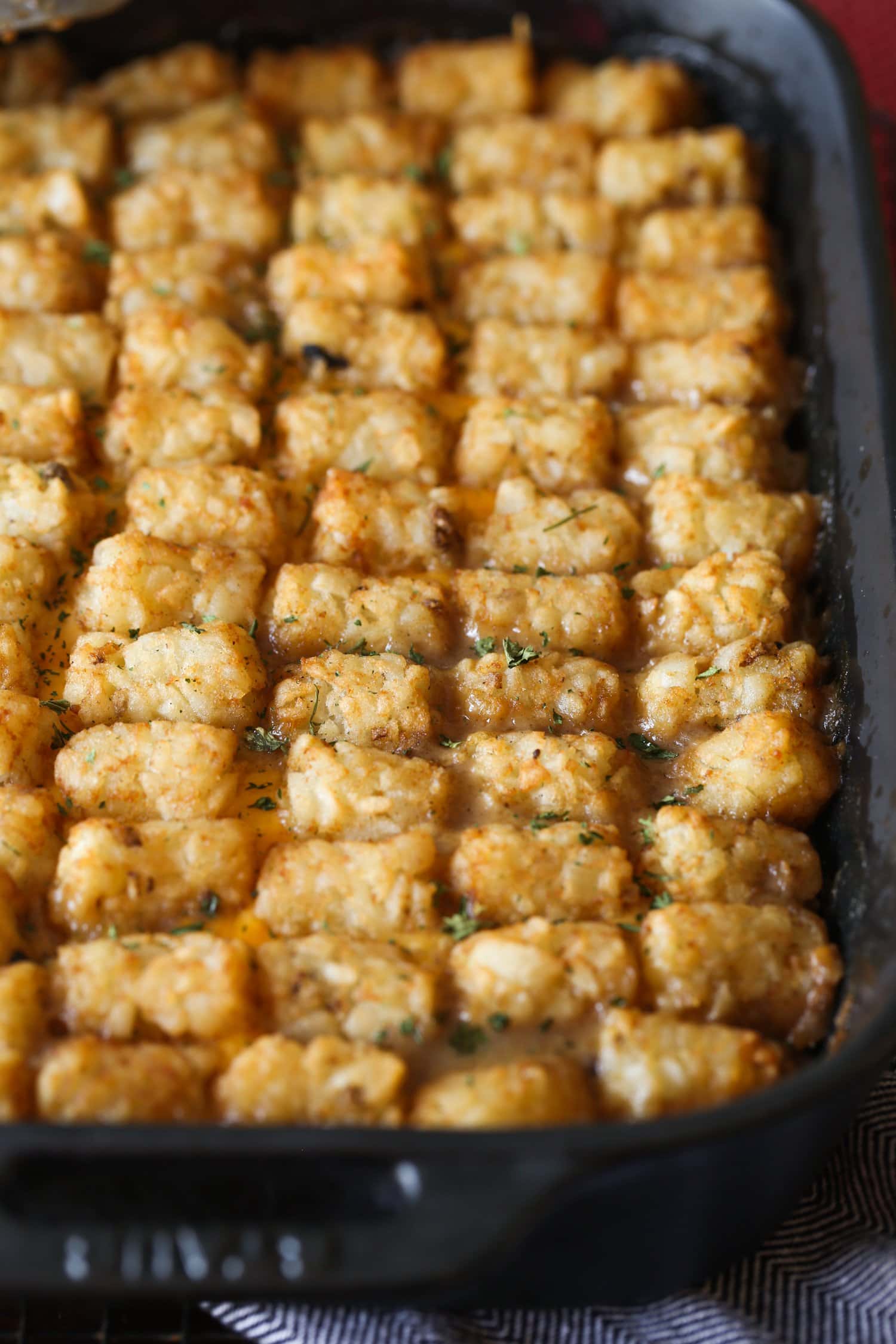 Baked tater tot casserole in a 9x13 pan.