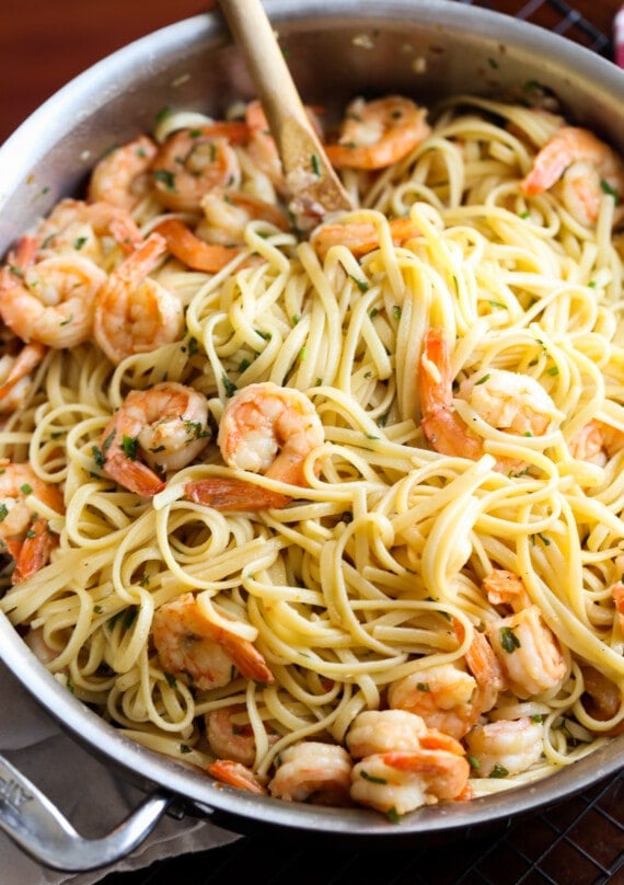 Shrimp scampi in a pan with linguine.