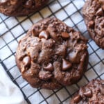 chocolate cookies with chocolate chips on a cooling rack