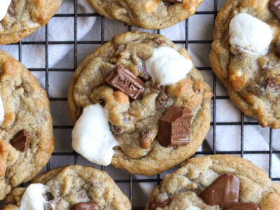 S'mores Cookies on a cooling rack with mini marshmallows and Hershey's chocolate