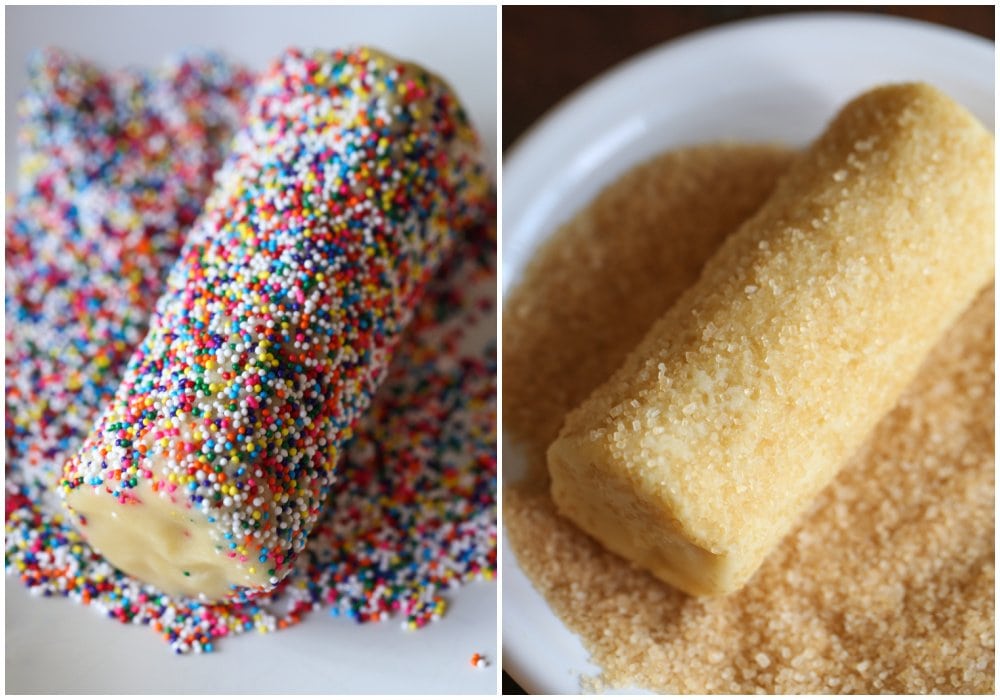 A butter cookie log in a plate of sprinkles, and a butter cookie log in a plate of coarse sugar.