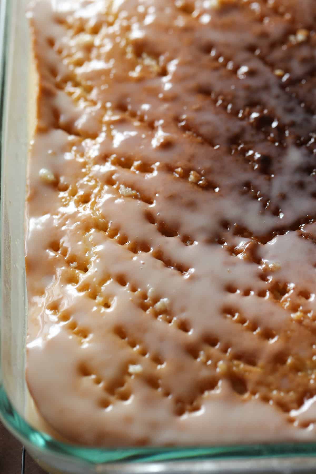 Cake with holes poked in and glaze on top