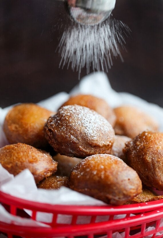 Fried Oreos being dusted with powdered sugar