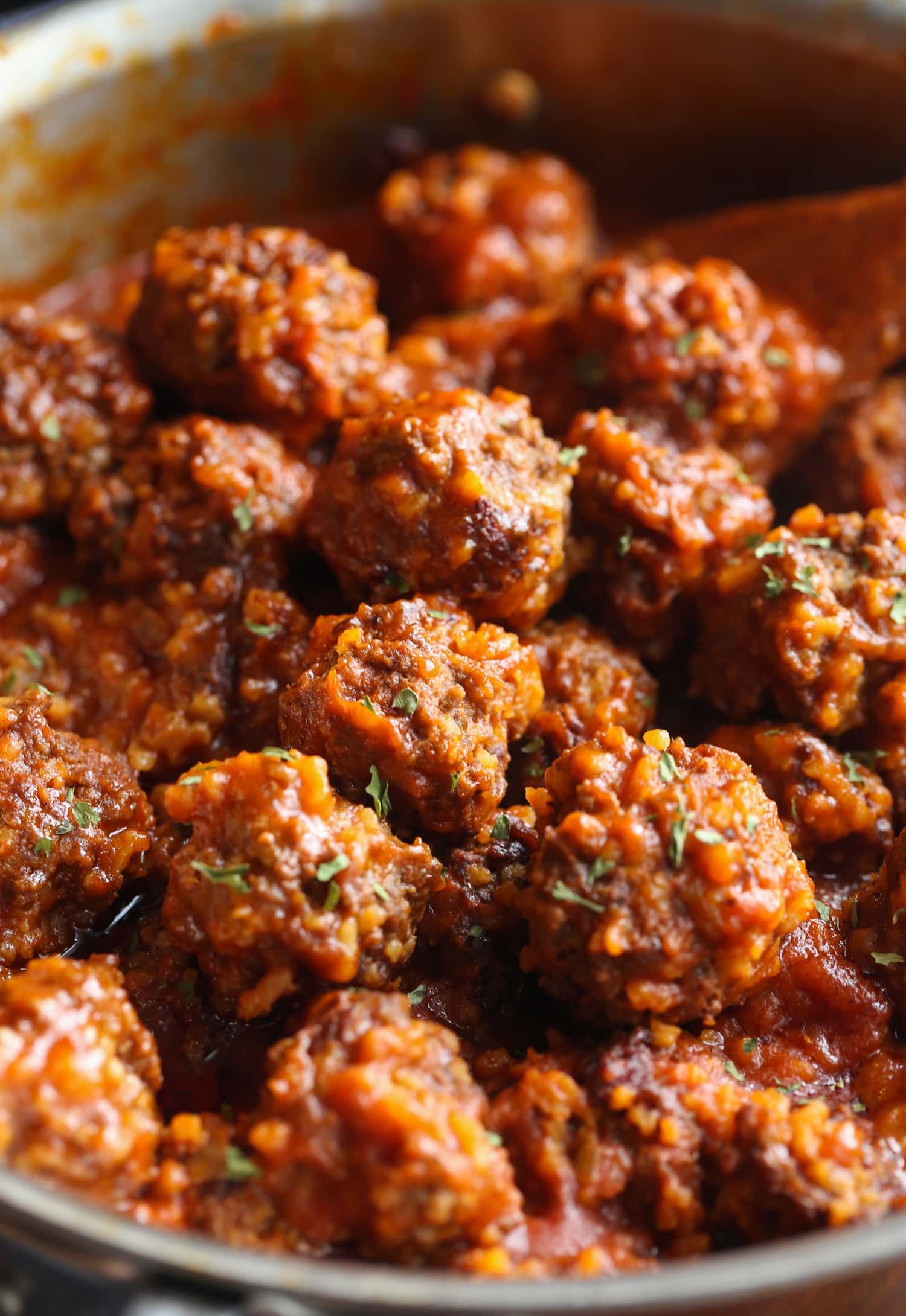 Beef meatballs packed with rice in a saucepan.