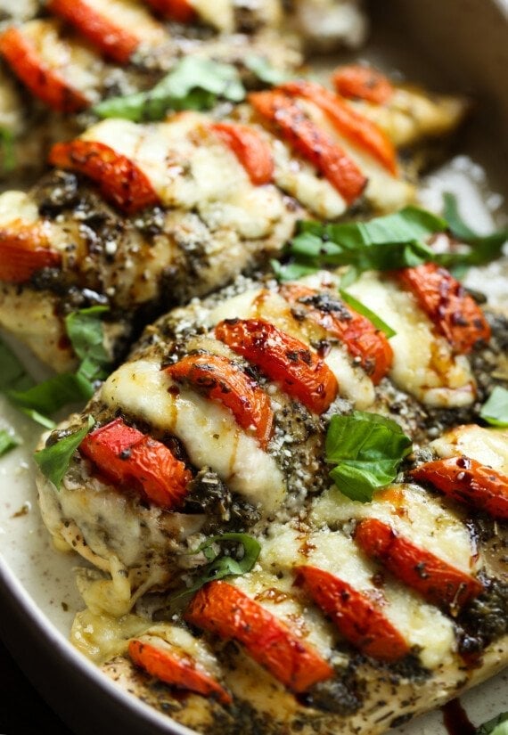 Caprese Chicken in a baking dish garnished with basil