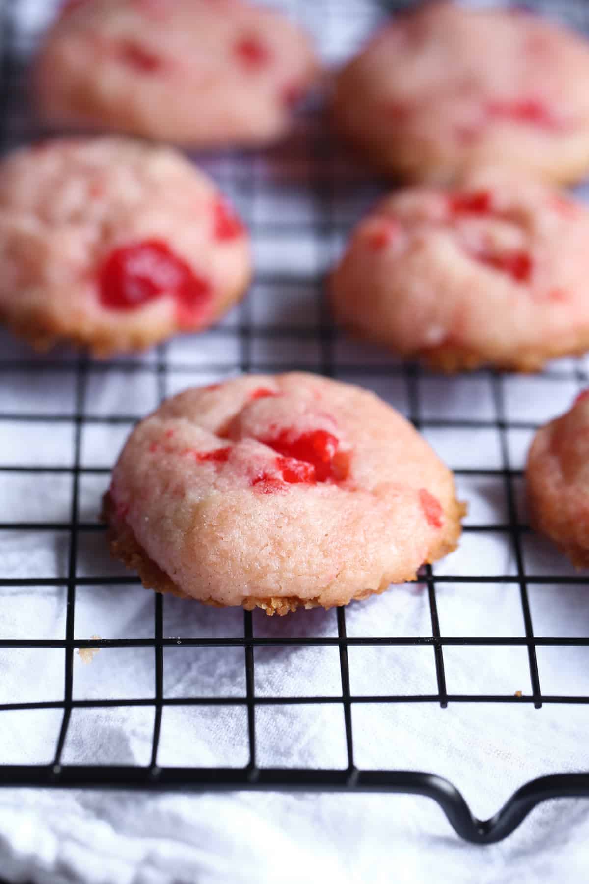 cherry cookies cooling on a wire rack