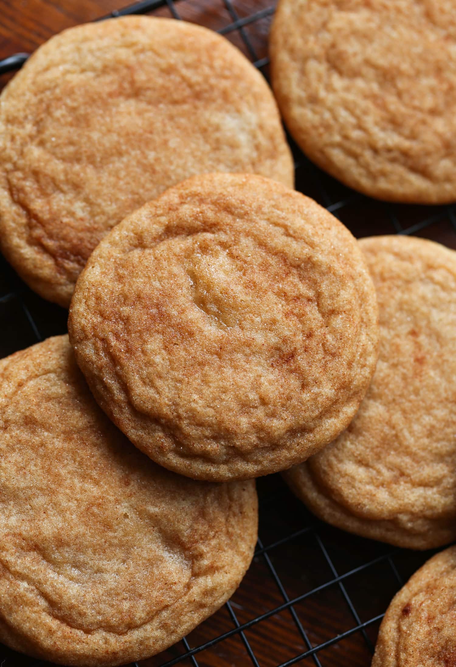 Snickerdoodle cookies on a cooling rack.