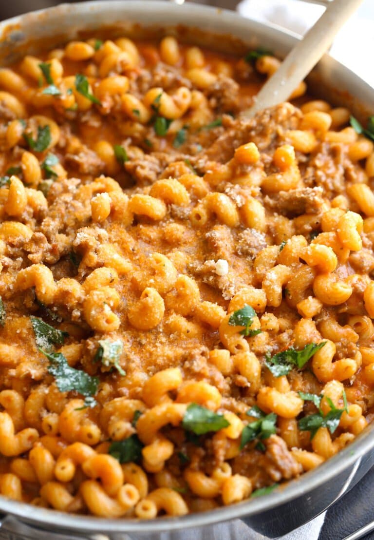 Creamy Italian sausage pasta in a frying pan.