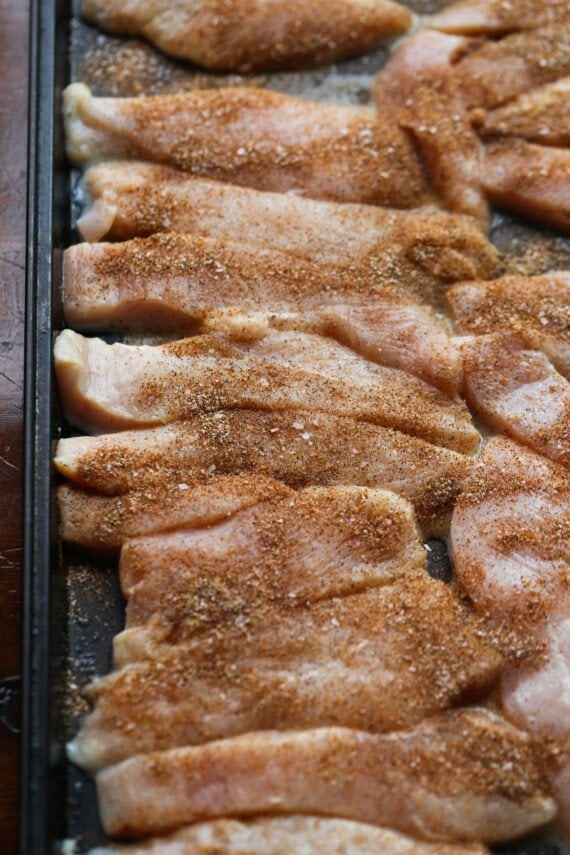 Marinated and seasoned tray of chicken tenders.