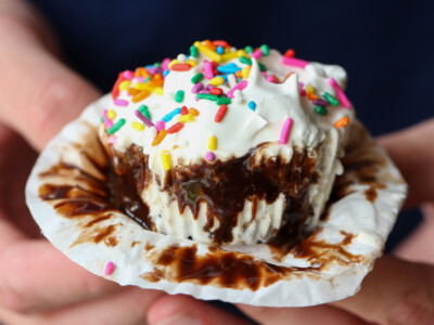 Holding an ice cream cupcake and unwrapping it