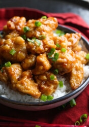 Orange chicken with chopped green onions.