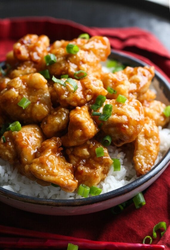 Orange chicken with chopped green onions.