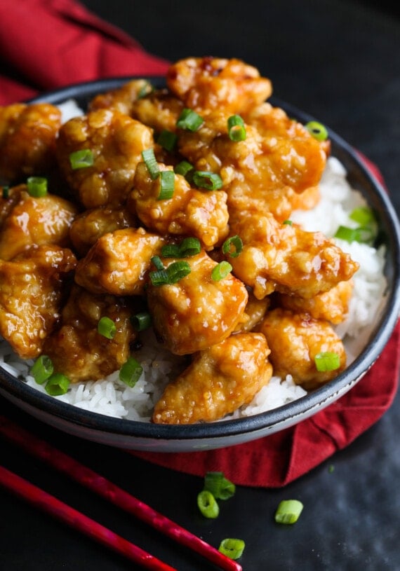 Orange chicken with green onions and rice.