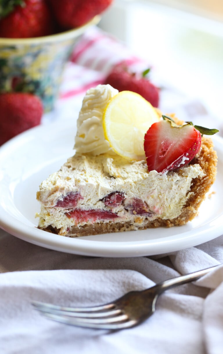 A slice of no-bake strawberry lemon ice box pie on a plate.