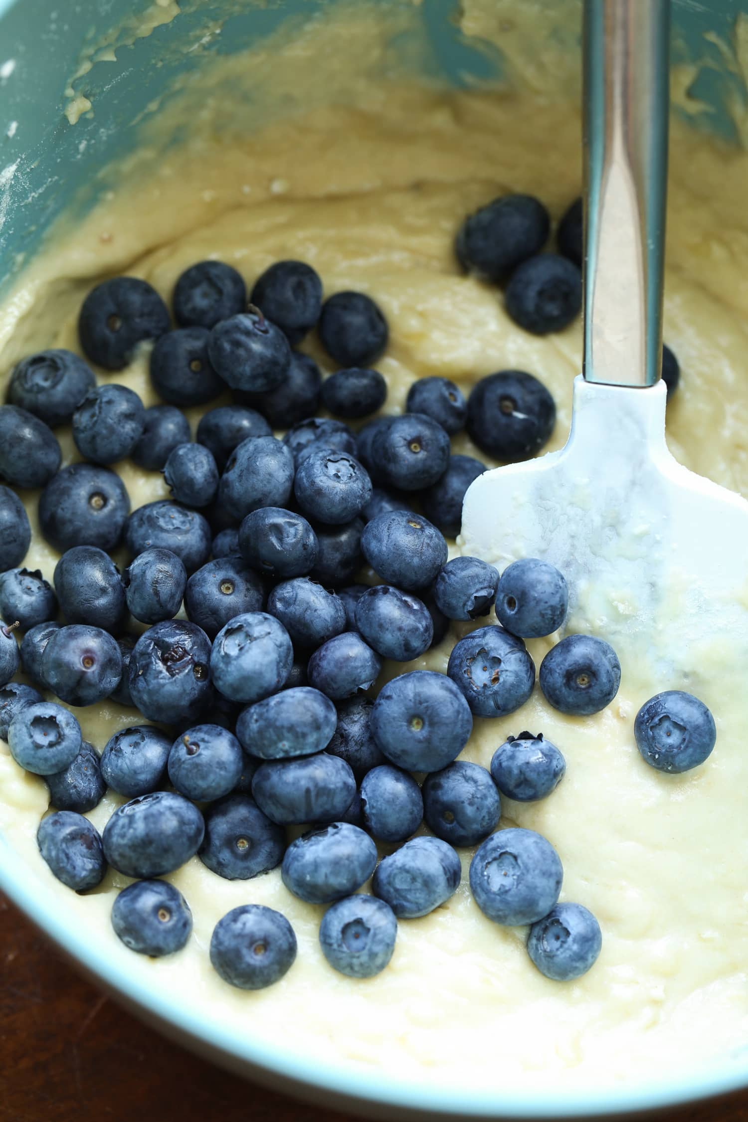 Mixed fresh blueberries into banana muffin dough.