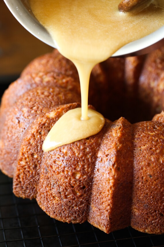 Glaze being poured on a banana pound cake.