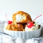 Fried ice cream with whipped cream and cherries.