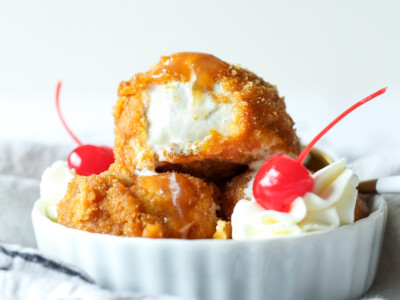 Fried ice cream with whipped cream and cherries.
