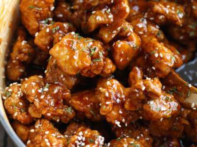 Sesame chicken in a bowl coated with sauce