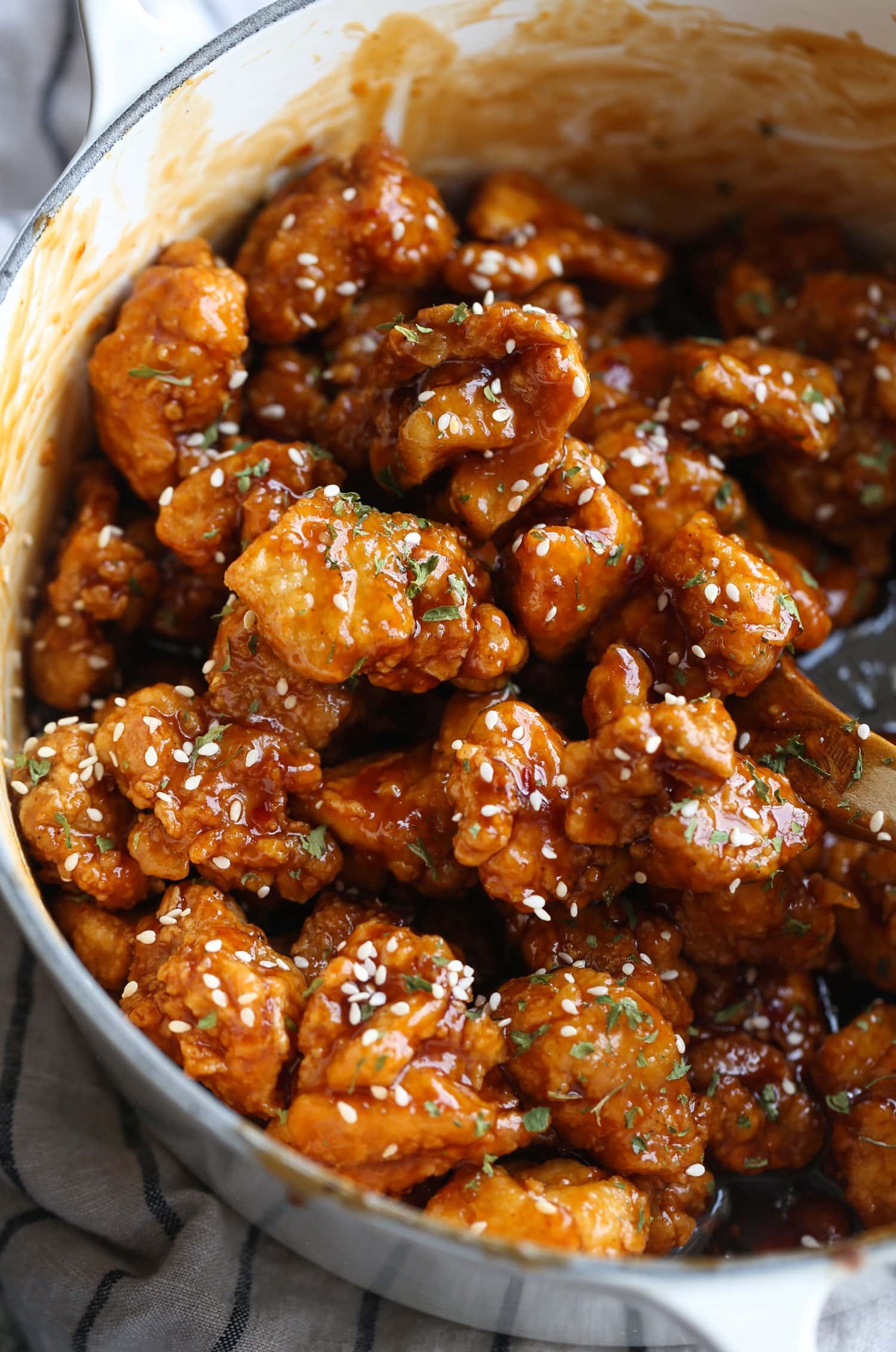 Sesame chicken in a bowl coated with sauce