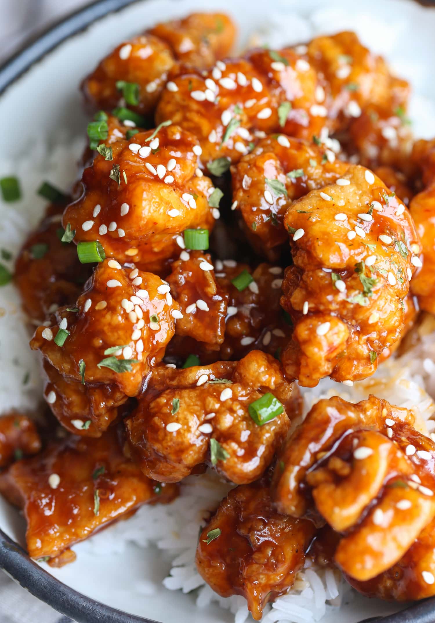 Sesame chicken on a plate with rice
