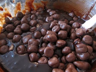 Brownie batter in a glass mixing bowl with chocolate chips