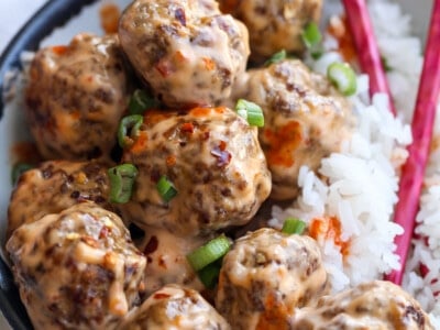 A pile of pork and beef meatballs with rice.