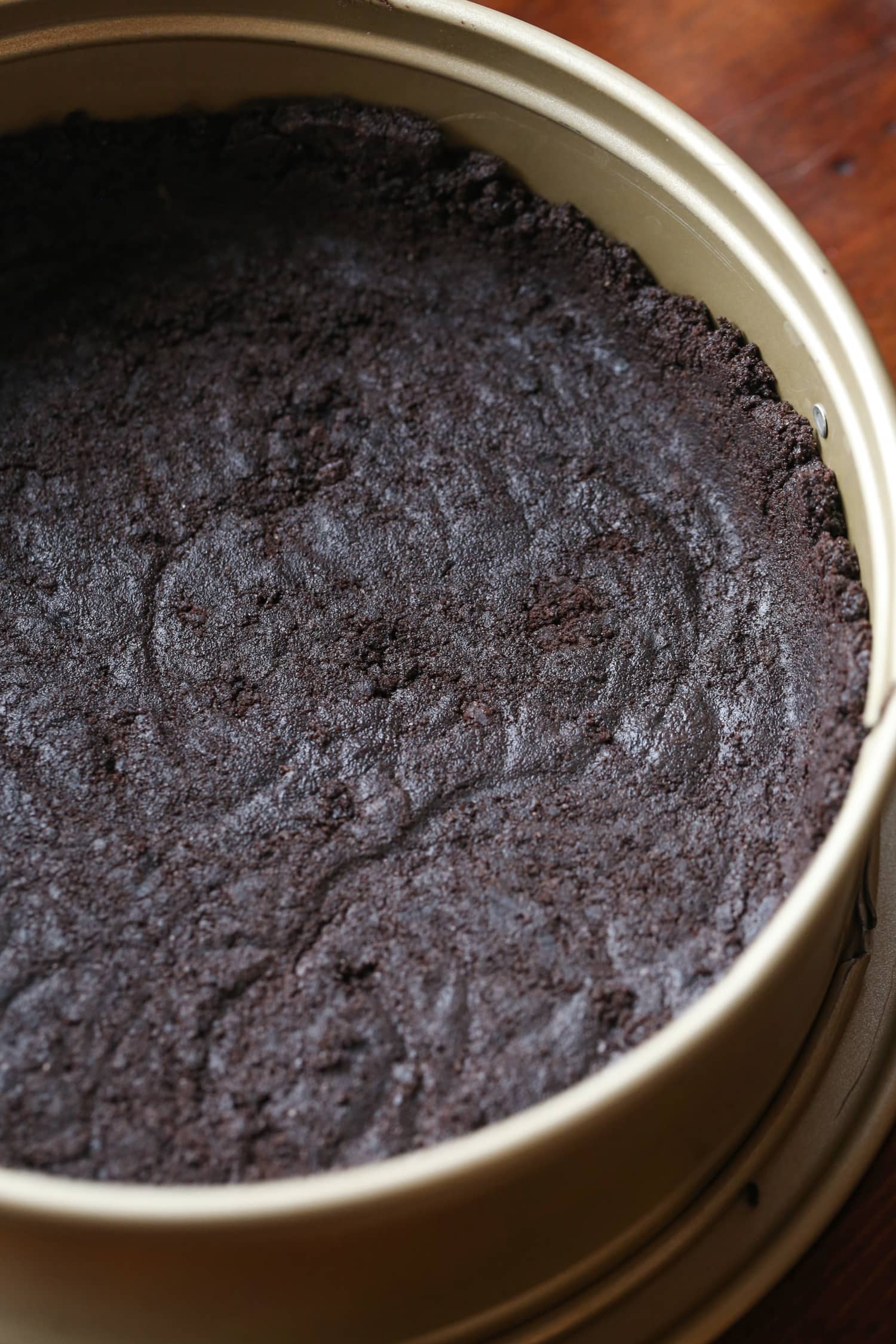 An Oreo cheesecake crust in a springform pan.