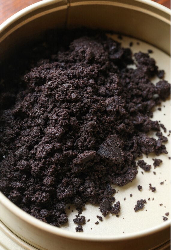 Oreo crumbs in a springform pan.