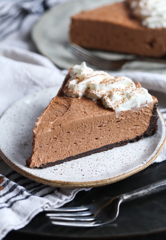 A slice of Nutella cheesecake with whipped cream.