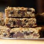 stacked oatmeal cookie bars with chocolate chips, raisins, and walnuts