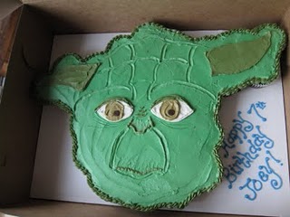 A collection of cupcakes with frosting over all of them decorated to look like one cohesive Yoda face