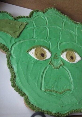 A close-up shot of a Yoda cupcake cake inside of a cardboard box