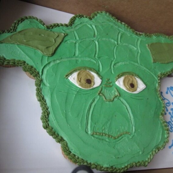 A close-up shot of a Yoda cupcake cake inside of a cardboard box