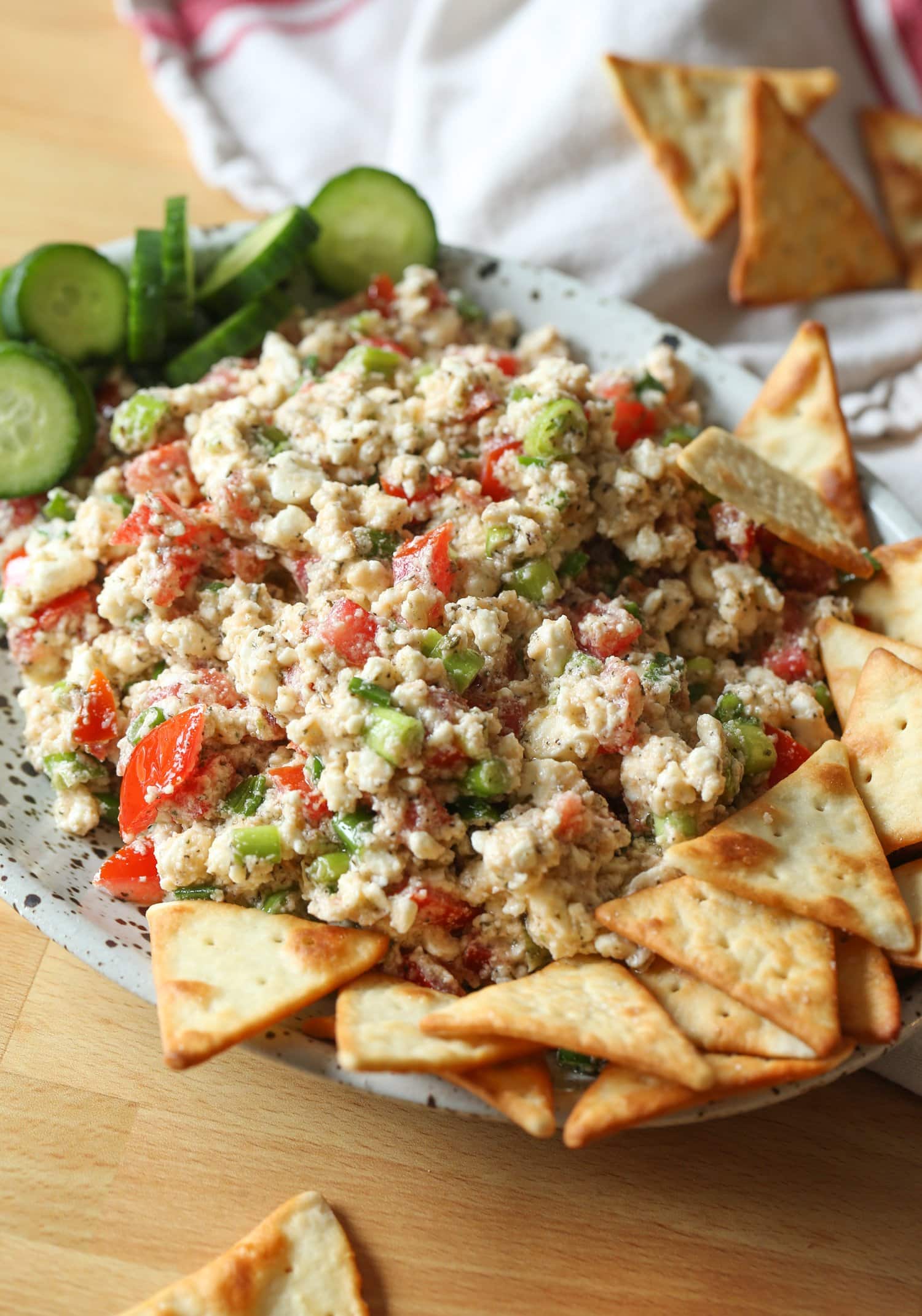 Dip on a platter with pita chips and veggies