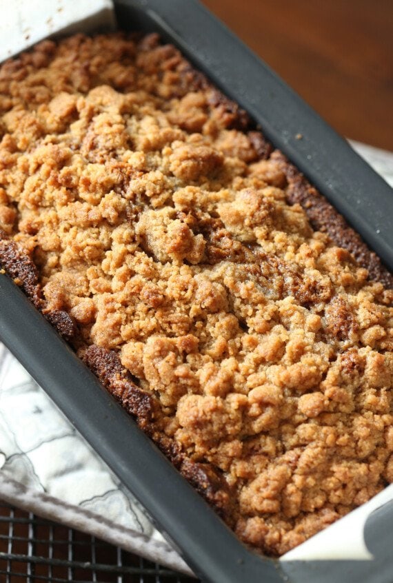 baked pumpkin bread in loaf pan with crumb topping