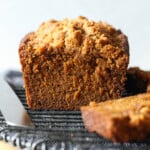 Loaf of pumpkin bread cut on a cooling rack