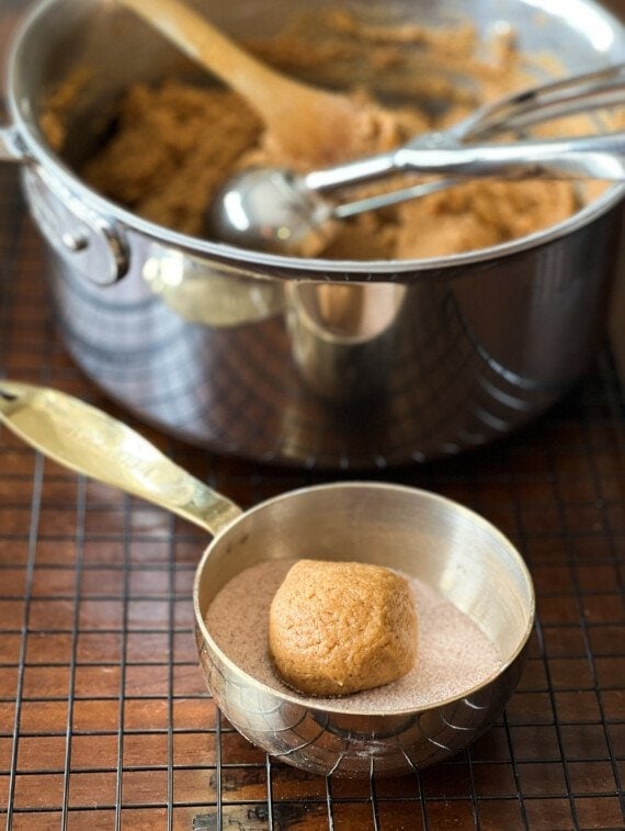 rolling cookie dough in cinnamon sugar