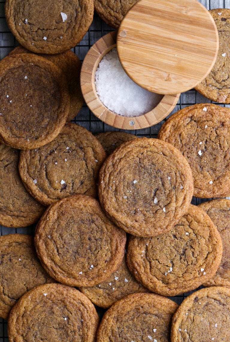 Chewy pumpkin cookies with flake sea salt on a cooling rack