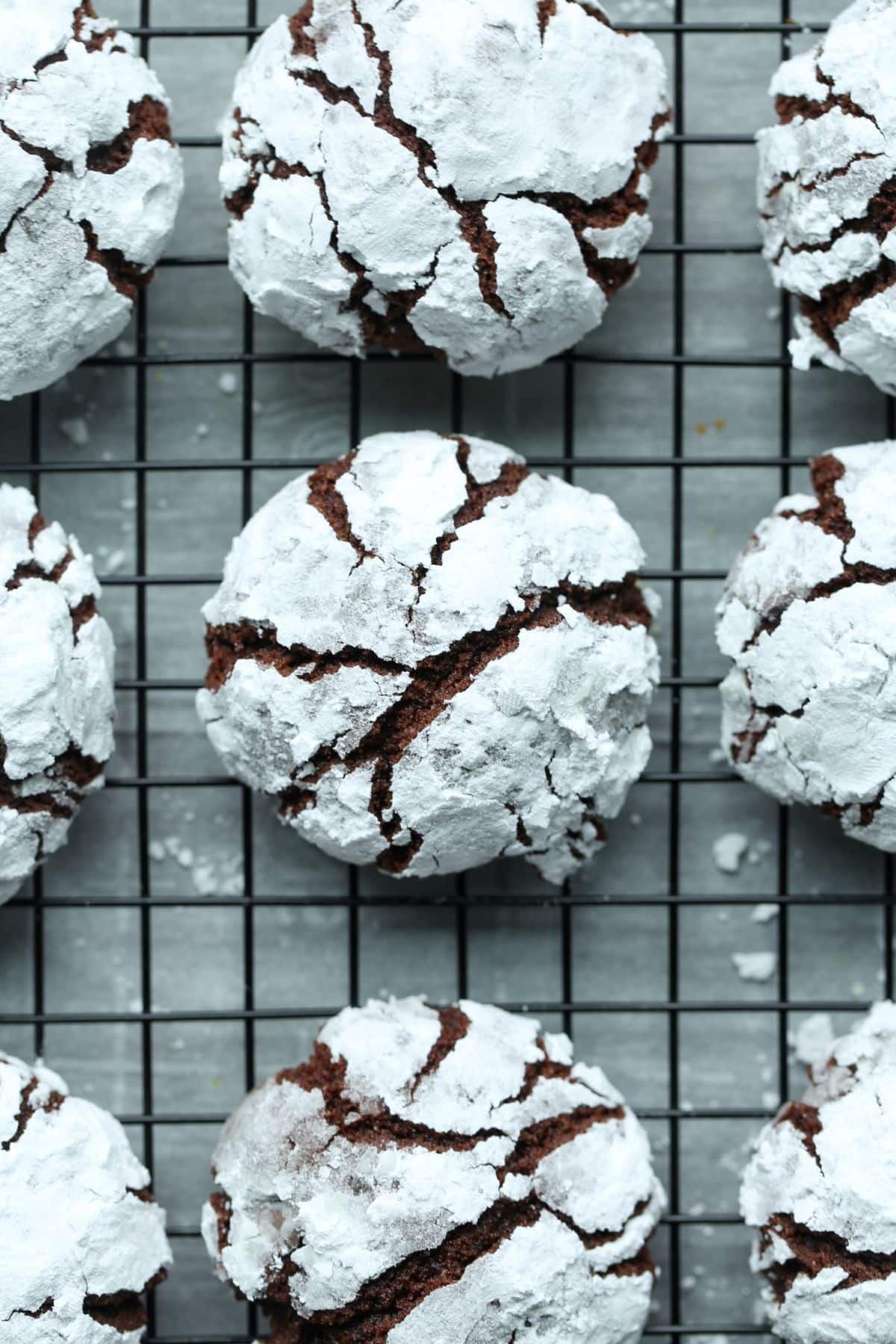 Chocolate crinkle cookies cooling on a wire rack.