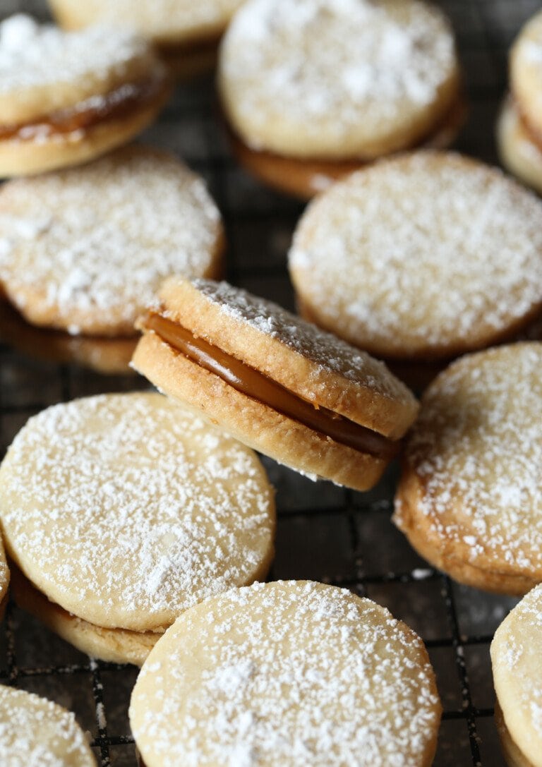 Alfajores cookies dusted with powdered sugar, filled with dulce de leche.