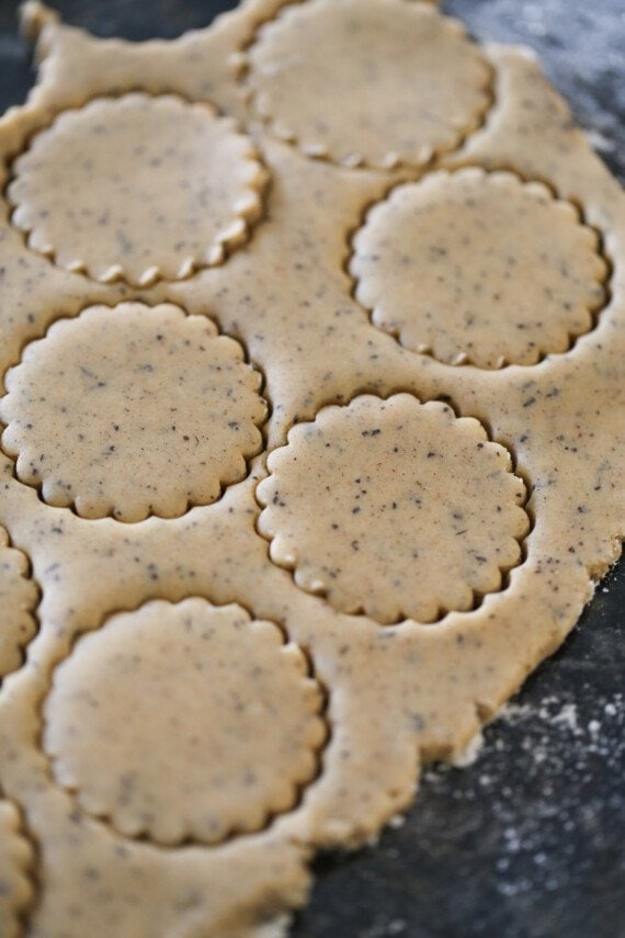 cookie dough cut out with a round scalloped cookie cutter