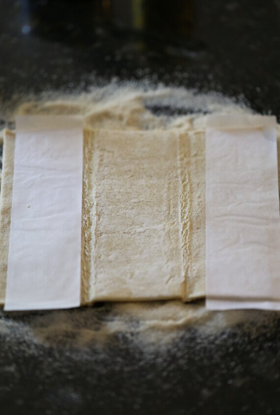 Folding Palmiers Dough Step 3: Thawed puff pastry is completely unfolded onto a sugar coated countertop.