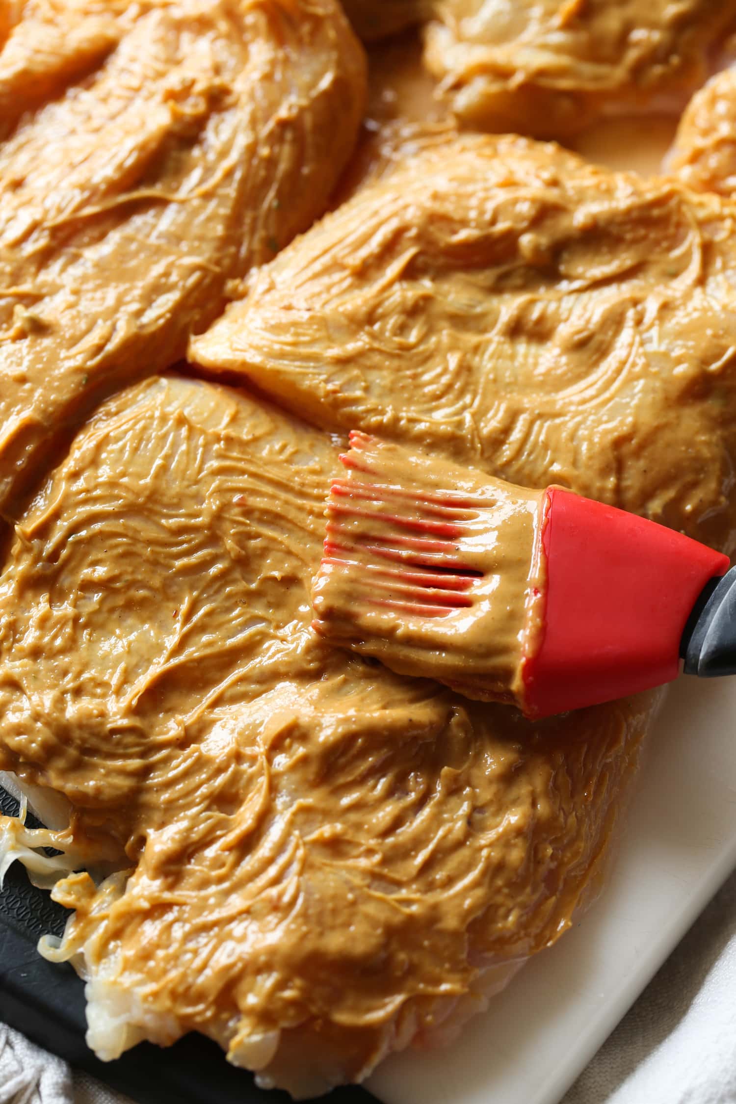 Chicken breasts are brushed with homemade Thai peanut butter sauce.