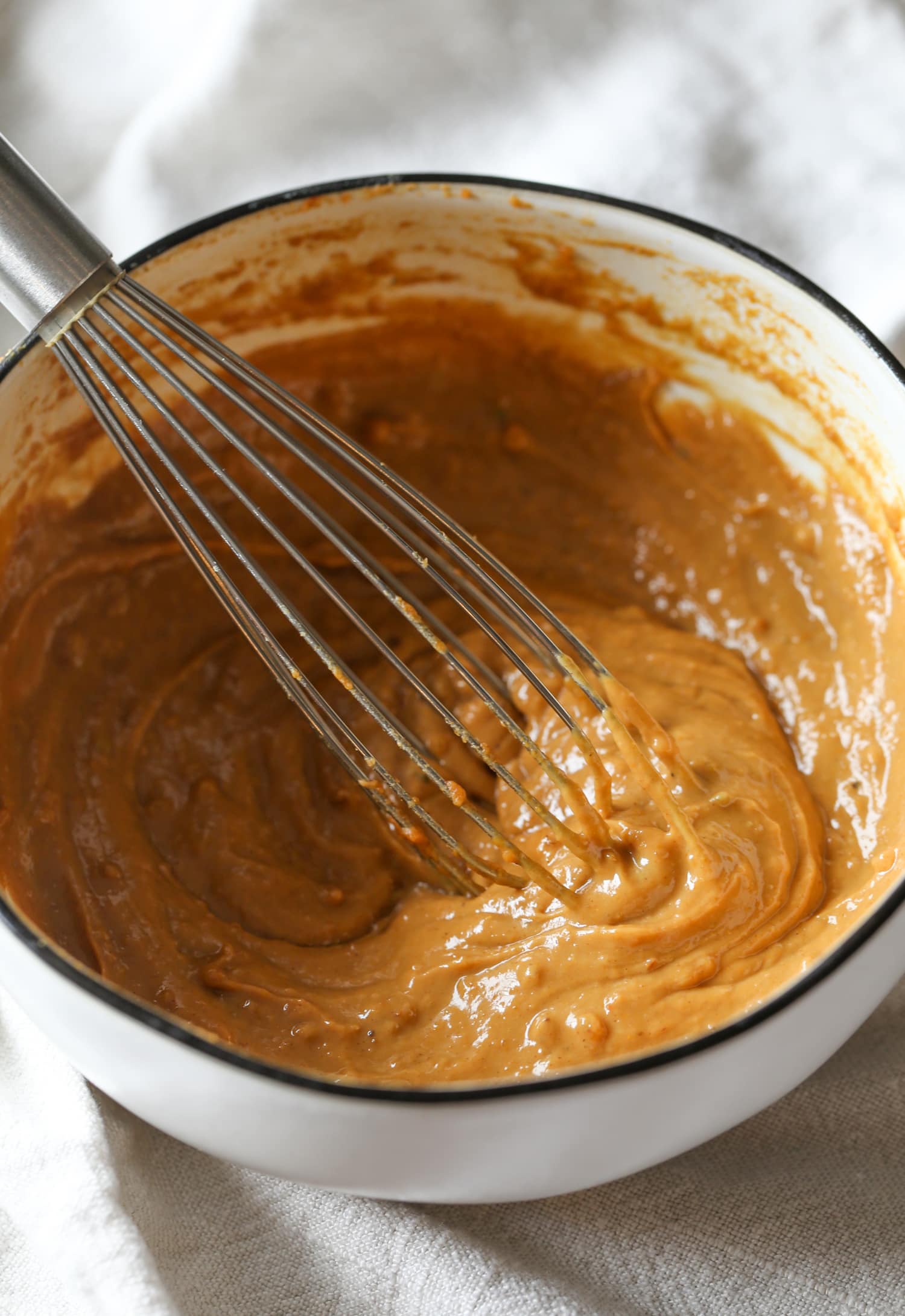 Peanut butter, lime juice, soy sauce, chili and spices are whisked together for the homemade peanut sauce.