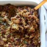 Cornbread Dressing in a baking dish with a spoon