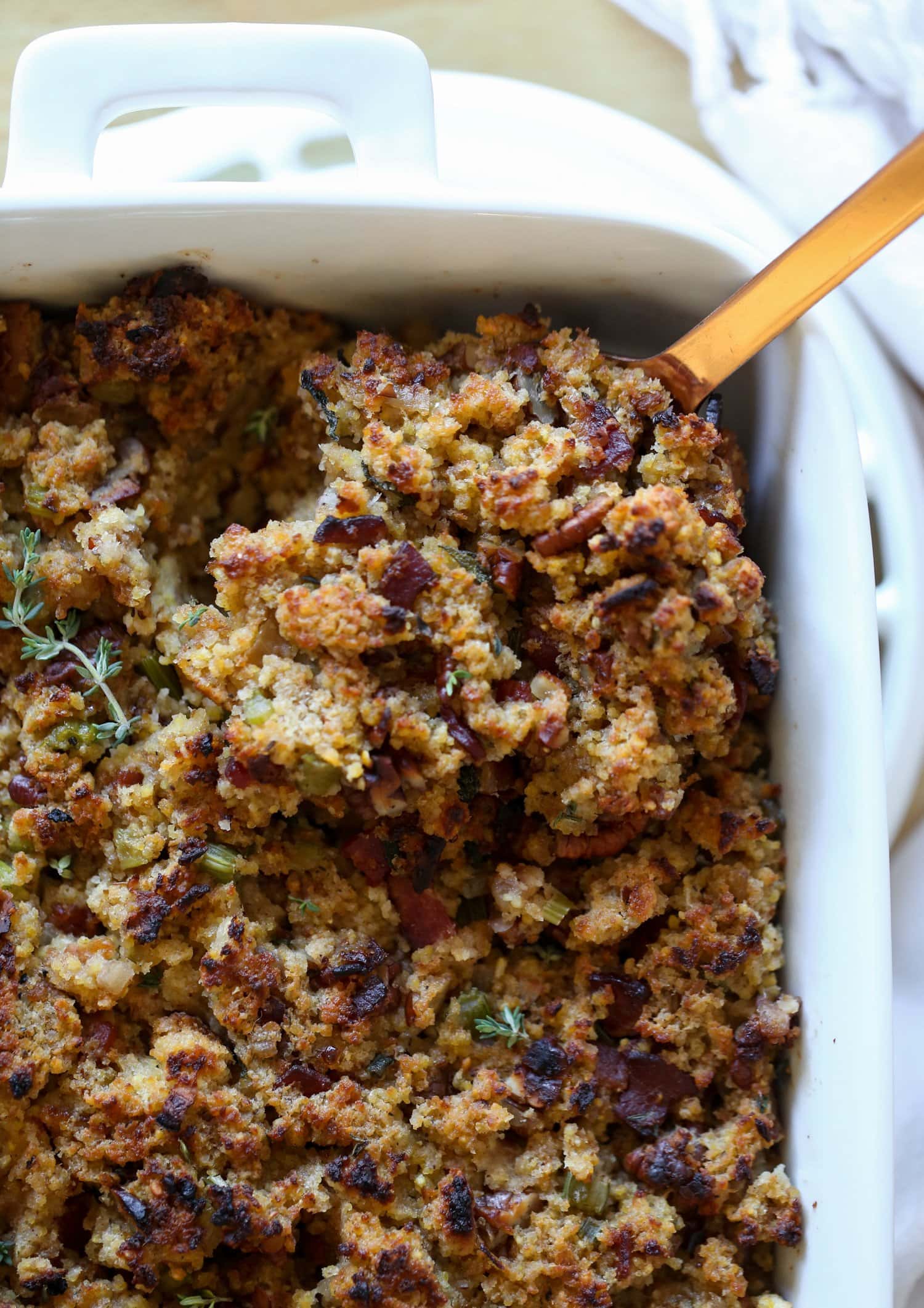 Cornbread Dressing in a baking dish with a spoon