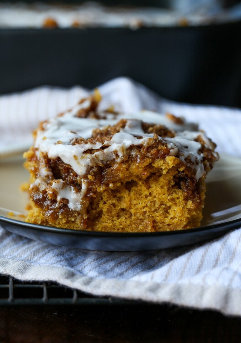 A slice of pumpkin cinnamon roll cake on a plate.